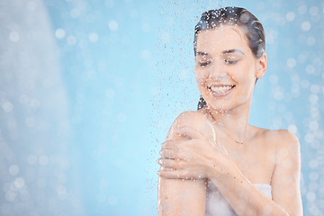 Image showing Cleaning, shower and woman with water in studio on blue background for beauty, wellness and body care. Spa hydration, skincare and happy girl washing for self care, health and hygiene in water drops