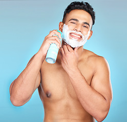 Image showing Man, face skincare or shaving cream in grooming routine, hair removal treatment or hair growth management. Portrait, smile or happy model and shave foam in beard wellness on Brazilian blue background