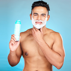 Image showing Man, facial beauty and shaving foam for beard grooming care portrait, hair removal or cosmetics hygiene in studio. Luxury skincare wellness, happy skincare treatment and shave face in blue background