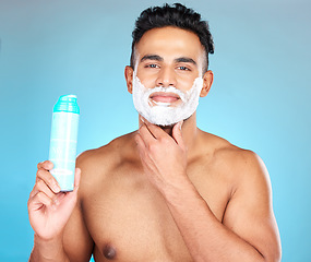 Image showing Face, skincare and man with shaving cream product in studio isolated on a blue background. Beauty, hair care and male model from Brazil with shave gel for beard grooming, cleaning and facial hygiene.