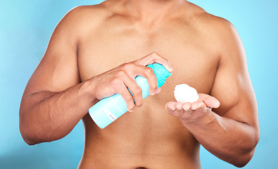 Image showing Shaving cream, hand and man with foam for hair removal, grooming or epilation in a studio. Product, skincare and closeup of mousse to shave a facial beard or body hair isolated by a blue background.