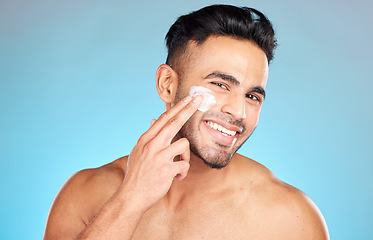 Image showing Cream, face and skincare man in studio for beauty, cosmetics and product promotion mockup with smile happy for benefits. Skin care, dermatology and young model with sunscreen application in portrait