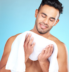 Image showing Cleaning, towel and face of man clean after wellness wash, facial cleaning routine and skincare mockup. Happiness, smile and person after bath or shower for body self car on blue studio background