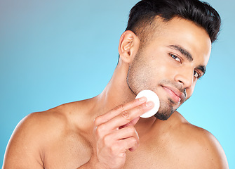 Image showing Beauty, skincare and cotton with portrait of man for facial, product and spa cosmetics. Massage, luxury and cleaning with face of model for toner, makeup remover and self care in blue background