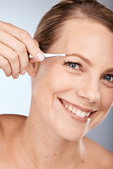 Image showing Portrait of woman, tweezers and eyebrow hair removal for clean cosmetics, face and beauty on studio background in Australia. Happy mature model pull hair for brows shape, skincare and facial wellness