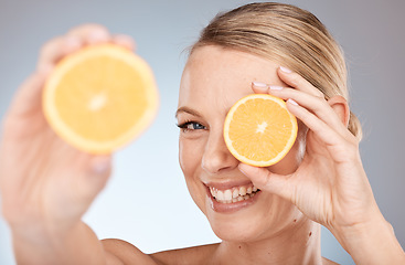 Image showing Skincare, beauty and orange for woman as natural facial with citrus and vitamin c fruit for health and wellness on studio background. Portrait, face and smile of Canada model for organic dermatology