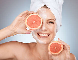 Image showing Woman, face mask or grapefruit skincare on studio background in Canada healthcare wellness, organic dermatology or vegan facial. Portrait, smile or happy beauty model with citrus fruit facial product