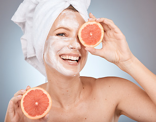 Image showing Skincare, grapefruit and portrait of a woman in studio with face cream, lotion or spf for skin routine. Health, wellness and model with citrus fruit for organic, natural and healthy facial treatment.