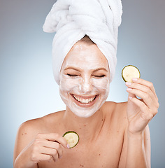 Image showing Laughing woman, skincare face mask and cucumber on studio background in acne dermatology, healthcare wellness or self care routine. Happy smile, beauty model and facial vegetables in organic grooming