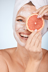 Image showing Grapefruit skincare, beauty mask and woman with facial detox, natural food and happy application against grey studio background. Acne, product and face portrait of a model with fruit for dermatology