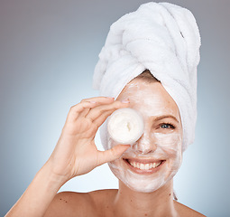 Image showing Portrait, facial and skincare with a model woman in studio on a gray background to promote a skin product. Face, smile and container with a happy female posing for natural treatment or antiaging mask