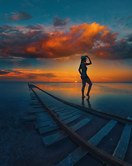 Image showing Woman at beauty sunset on salty lake