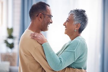 Image showing Happy, love and romance with a senior couple laughing, hugging or dancing together in their home. Dance, romantic and smile with a happy mature man and woman enjoying their retirement while bonding