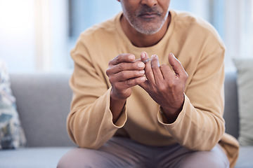 Image showing Mature man, hands or touching wedding ring on sofa in house, home or marriage counseling in divorce, break up or loss. Sad, anxiety stress or mental health for widower or middle aged person with band