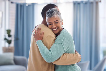 Image showing Hug, love and trust with a senior couple bonding in the living room of their home together. Happy, smile and embrace with a senior man and woman hugging while enjoying retirement in their house