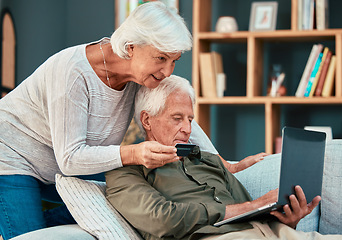 Image showing Senior couple, credit card and laptop on home sofa for ecommerce, online shopping and paying bills with fintech banking app. Old man and woman together in lounge with bank details to pay or purchase