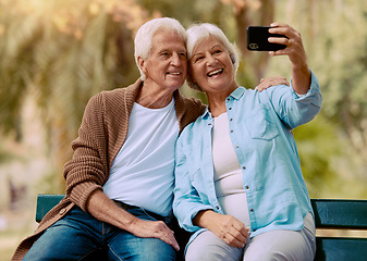 Image showing Senior couple, phone selfie and smile on park bench for love, care and social media profile picture of a happy retirement. Old man and woman outdoor together for happiness, support and bonding