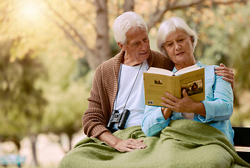 Image showing Old, people and book with a mature couple reading in the park for knowledge and education. Bonding, read and love with a husband and wife with a novel or story in a garden relaxing in retirement