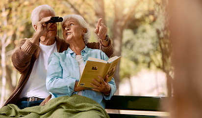 Image showing Happy senior couple bird watching in park for relax bonding time together, freedom and retirement peace on outdoor bench. Elderly marriage love, binoculars and book reading woman with man pointing