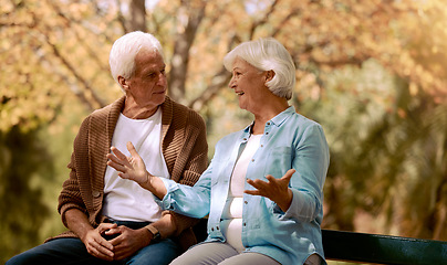 Image showing Nature, park and retirement with a senior couple sitting together on a wooden bench outdoor in a garden. Spring, love and summer with a mature man and woman bonding outside in the countryside