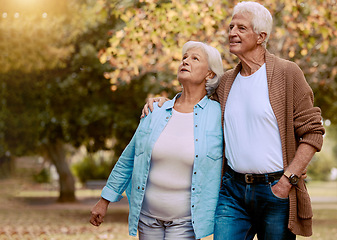 Image showing Senior couple walking in park for retirement, love and care together to enjoy quality time, marriage and relationship. Old man, woman and elderly people in autumn garden, nature and relax outdoors