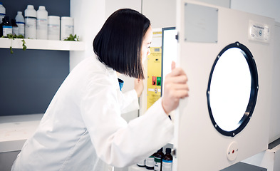 Image showing Science, woman and scientist in laboratory with incubator, check for experiment, research and scientific innovation. Professional, phd doctor and chemistry, physics or biotechnology study in lab.
