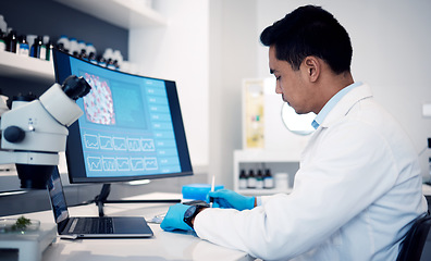 Image showing Man, scientist and computer with virus, bacteria and research data in laboratory. Science worker writing notes on vaccine, development or dna on technology, digital analytics or pharmaceutical health