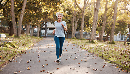 Image showing Exercise, senior and woman running in park for fitness, health and wellness mock up. Sports, retirement and happy elderly female from Canada jog, exercising or training outdoors alone for marathon.