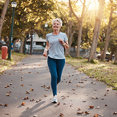 Image showing Park, running and fitness with a senior woman outdoor for cardio or endurance training in summer. Sports, exercise and health with a mature female pensioner outside for a run during retirement