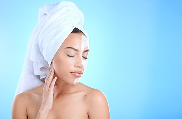 Image showing Face, skincare cream or woman in studio for beauty self care using dermatology product after shower in bathroom. Mask, relaxing or model grooming with facial cosmetics with mockup on blue background