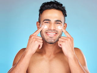 Image showing Skincare, eye cream and portrait of man for facial cosmetics, hygiene products or sunscreen in hands. Face, dermatology and male model wellness or spa happiness with smile in blue background studio