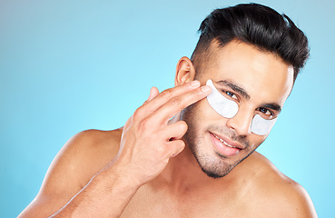 Image showing Man, hands and face with eyes patch for skincare portrait, beauty wellness or luxury spa cosmetics. Model, smile and happy in studio for dermatology care, eye care make product and facial cleaning