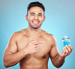 Image showing Man, perfume and aftershave bottle for marketing, advertising and mockup for glass container, product placement and cosmetics. Portrait of India model with a smile for parfum, promo and aftershave