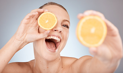 Image showing Happy, skincare or woman with an orange for beauty wellness, natural vitamin c cosmetics or healthy diet in studio. Smile, glow or portrait excited girl model showing dermatology benefits of fruits