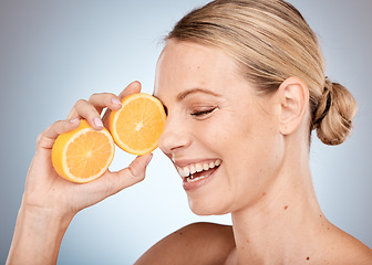 Image showing Skincare, beauty and woman with orange in studio for spa wellness, dermatology and facial treatment. Vitamin c, cosmetics and happy girl with fruit for natural, healthy and organic beauty products