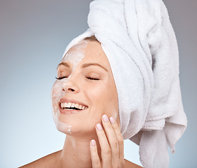 Image showing Skincare, cream and woman from the shower, happy cleaning and marketing beauty against a grey studio background. Spa smile, face mask and model with application of sunscreen for body care and health