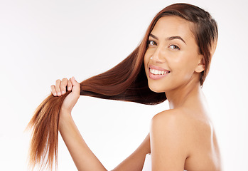 Image showing Woman, beauty and holding long hair in studio background with smooth texture, shine and wellness from hair salon treatment, shampoo and cosmetics. Happy model portrait, strong hair care and growth