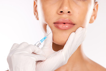 Image showing Doctor hand, botox and woman with collagen, needle and face in studio background. Plastic surgery, lip filler and cosmetic lip injection for youth for skincare, natural look and medical expert