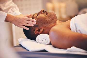 Image showing Hands, head and massage with a man in a spa on a bed or table for wellness, luxury or stress relief treatment. Relax, zen and beauty with a male customer lying in a health center for physical therapy