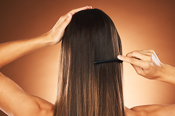 Image showing Hair care, salon and back of woman brushing hair, healthy beauty and comb hairstyle against a brown studio background. Wellness, morning routine and model with straight hair treatment for haircare