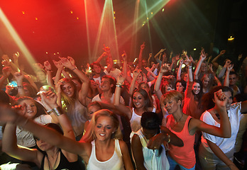 Image showing Concert music, rock and crowd of people with disco party lights for dance, performance and singing together in psychedelic festival. Night club, techno and rave with group of people or youth dancing