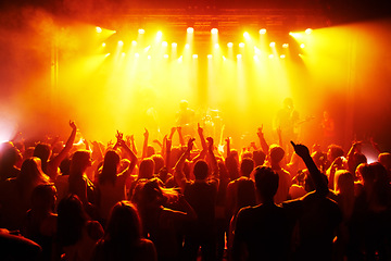 Image showing Rock hands, concert and music festival with crowd red disco lights for energy, dark and gen z psychedelic dance, celebration and party. Band, musician and group of people in the audience with freedom