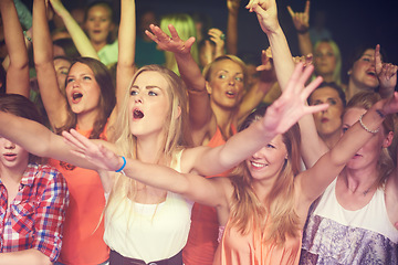 Image showing Concert, music festival and crowd of women or audience in night club, dance event and singing celebration with lights, disco and club lifestyle. Fans, group of people or youth at rave or techno party