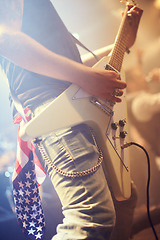 Image showing Guitar, man and performance in USA at night on stage, party and concert for punk, rock and metal music festival. Electric guitarist, hands and musician, artist and band at event with American flag