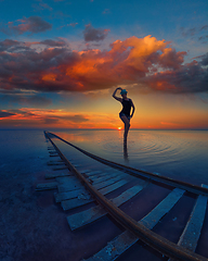 Image showing Woman at beauty sunset on salty lake
