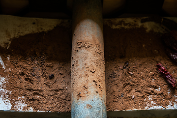 Image showing Grinding cacao beans with chili peppers