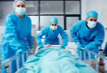 Image showing Surgery team, bed and rush in hospital, healthcare or patient emergency. Busy, medical staff or doctors with sick person, mask or nurses ready for procedure, health and wellness for treatment or cure