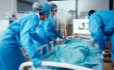 Image showing Women, man and hospital bed in motion blur of emergency surgery, healthcare wellness or risk condition operation. Doctors, nurses and medical workers with patient in busy er, theatre room or teamwork