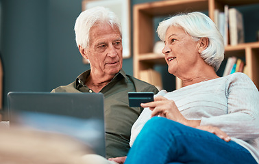 Image showing Senior couple, laptop and credit card for online shopping, ecommerce and paying bills online while talking about savings, investment and retirement. Old man and woman together for banking payment