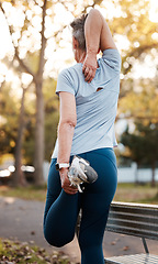 Image showing Back, senior woman and stretching outdoor for workout, wellness and health. Exercise, mature female or elderly lady training, fitness and practice for balance, cardio and performance for retirement.